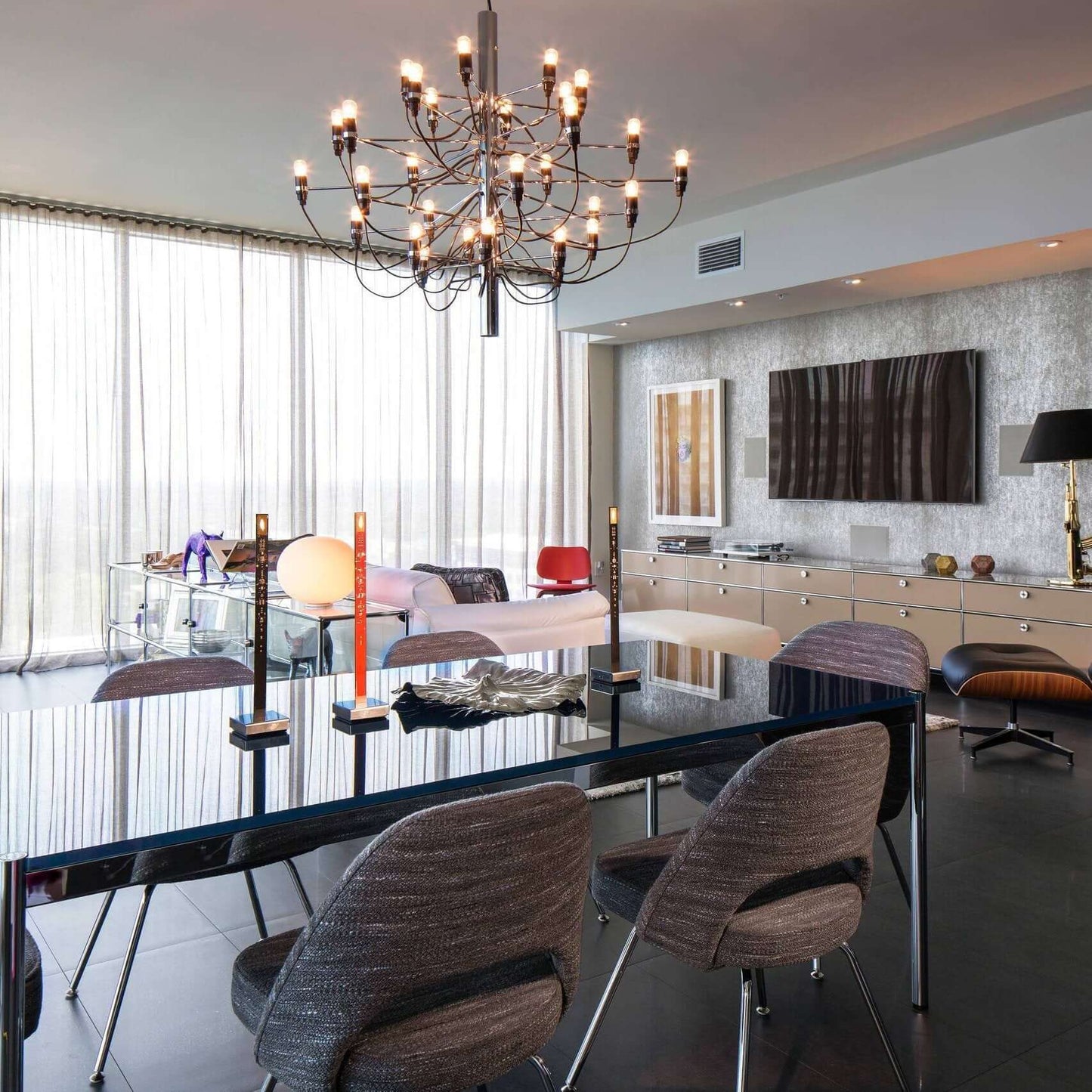 Side view of a matte black metal chandelier showcasing its multi-tiered, sculptural form