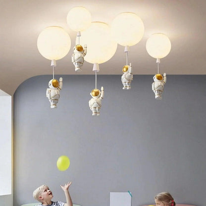 Detail of astronaut figurine suspended from polyester pendant light shade