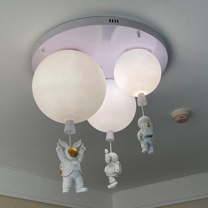 Nursery room bathed in soft light from a playful astronaut pendant light