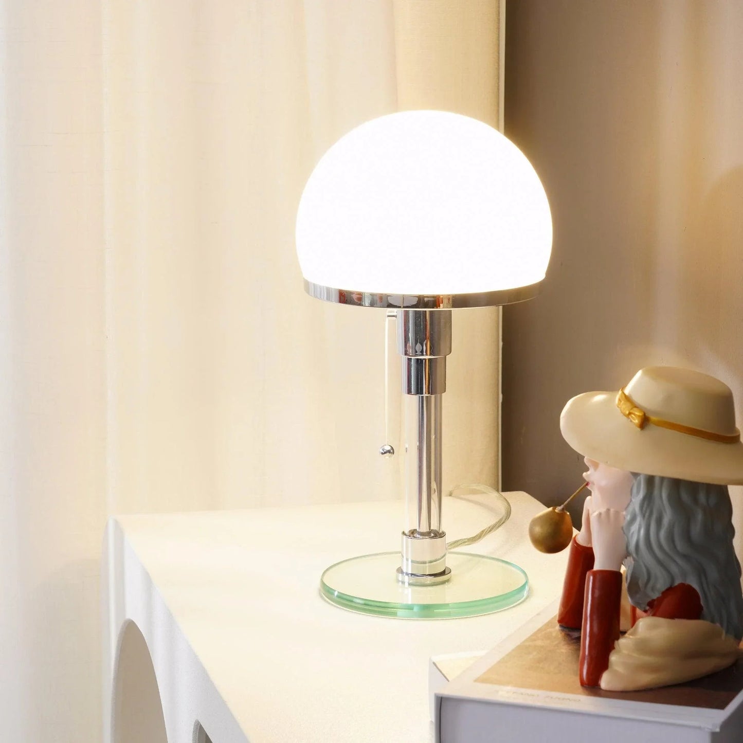 Lumotrot glass dome table lamp creating a warm, ambient glow on a desk