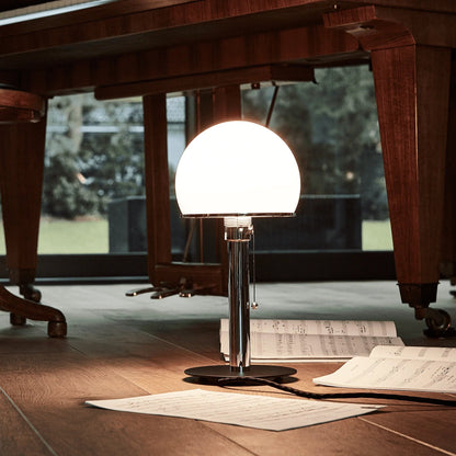 Close-up of the opal glass dome and polished nickel hardware on the table lamp