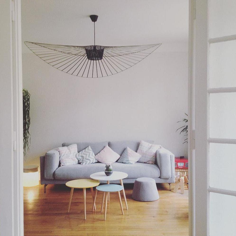 Black metal wire pendant light creating a serene ambiance in a modern living room