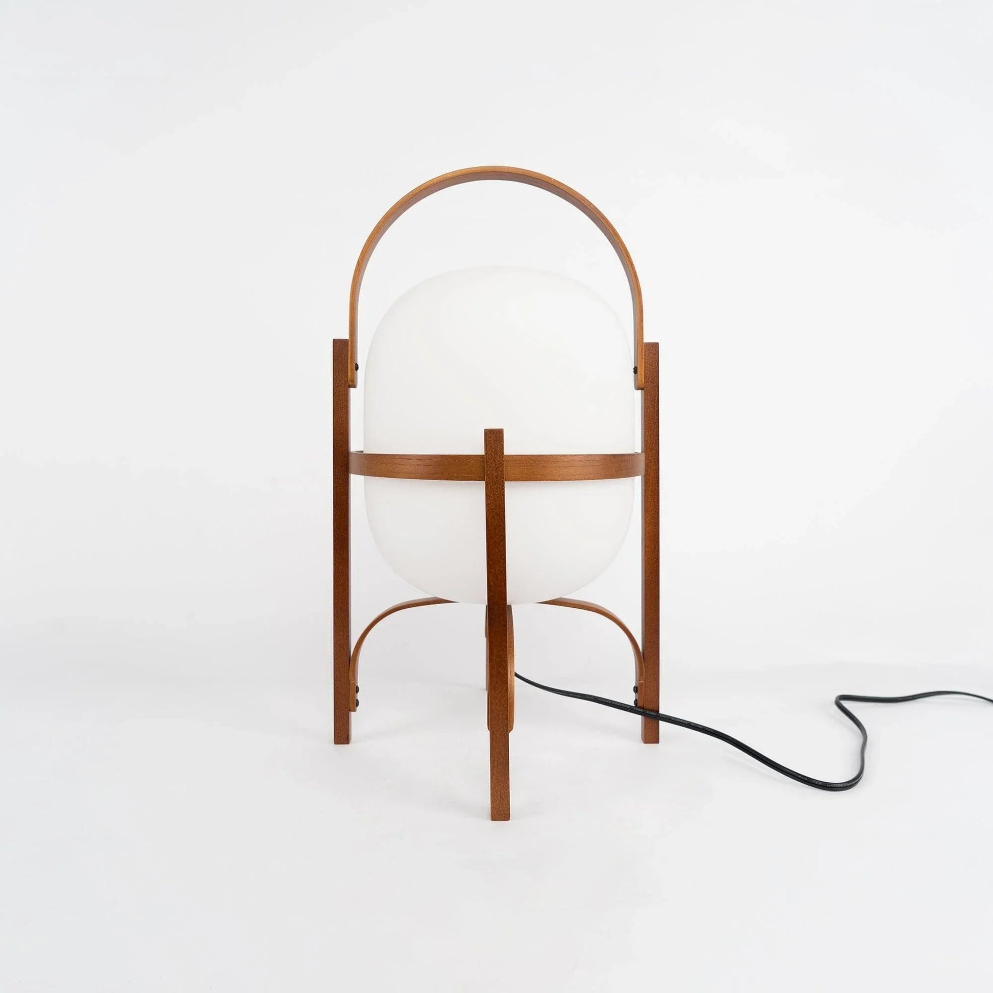 Scale and detail of the wood and glass table lamp base and cord