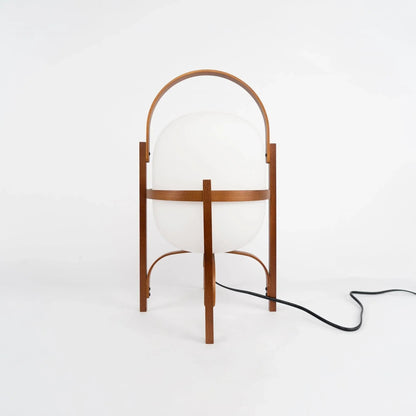 Scale and detail of the wood and glass table lamp base and cord