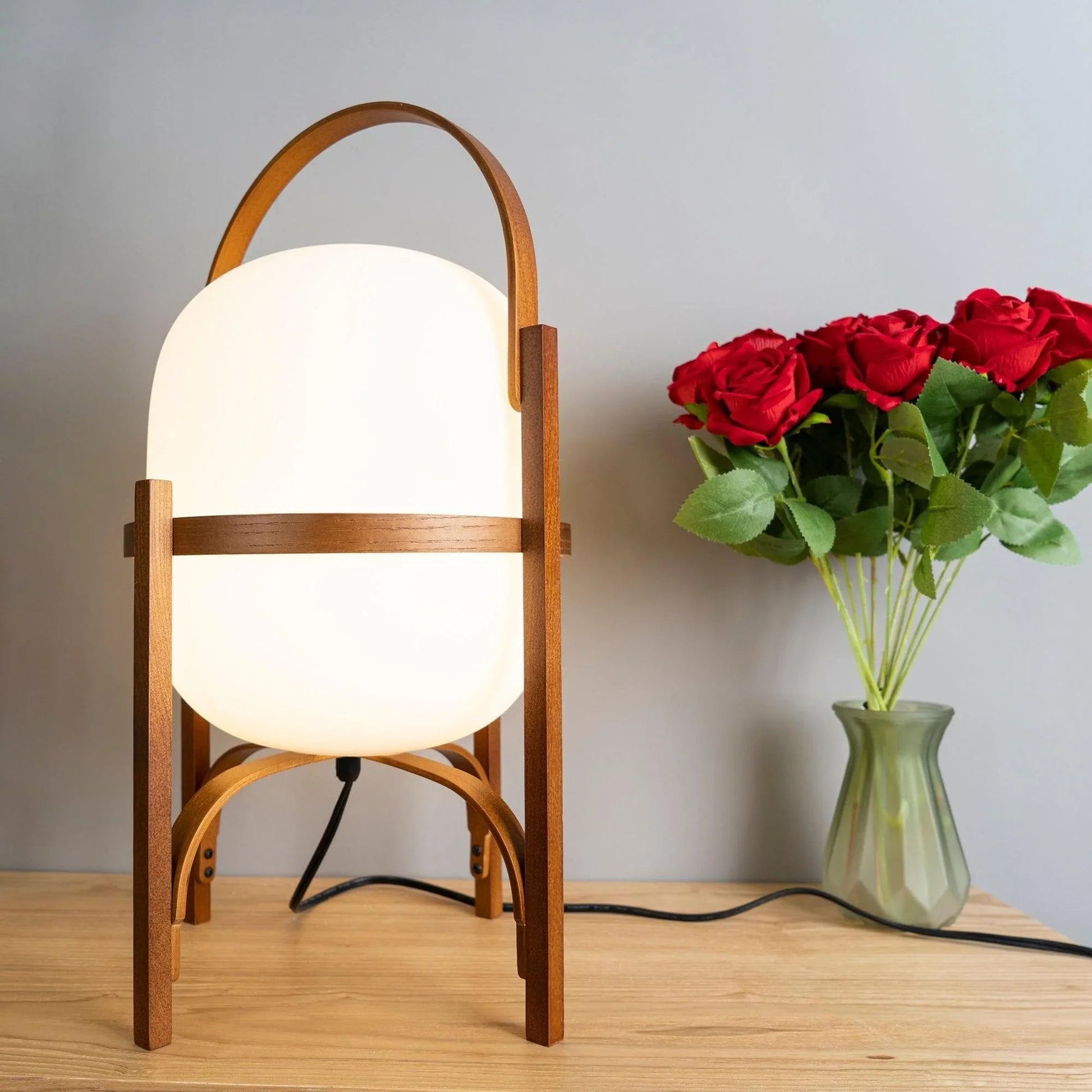 Close-up of the natural wood grain and smooth opal glass diffuser