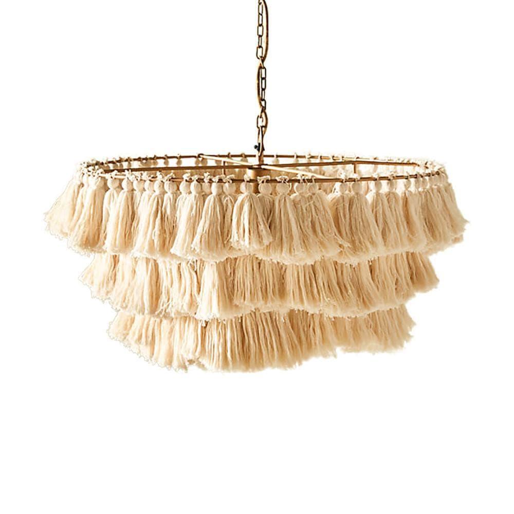 Bohemian fabric tassel chandelier creating a warm ambiance in a stylish bedroom setting