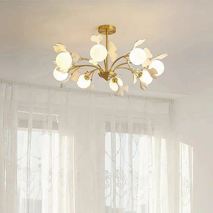 Ceiling-mounted brass chandelier featuring organic ceramic leaf design