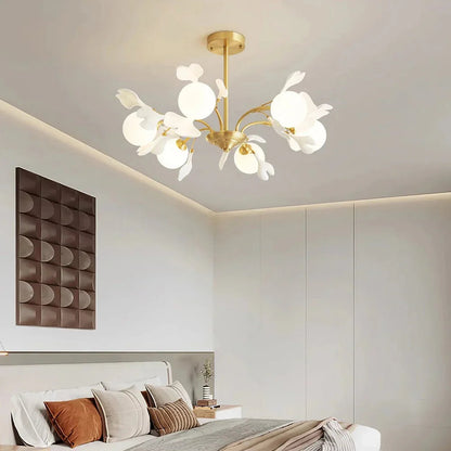 Unique tiered silhouette of a brass and ceramic leaf chandelier