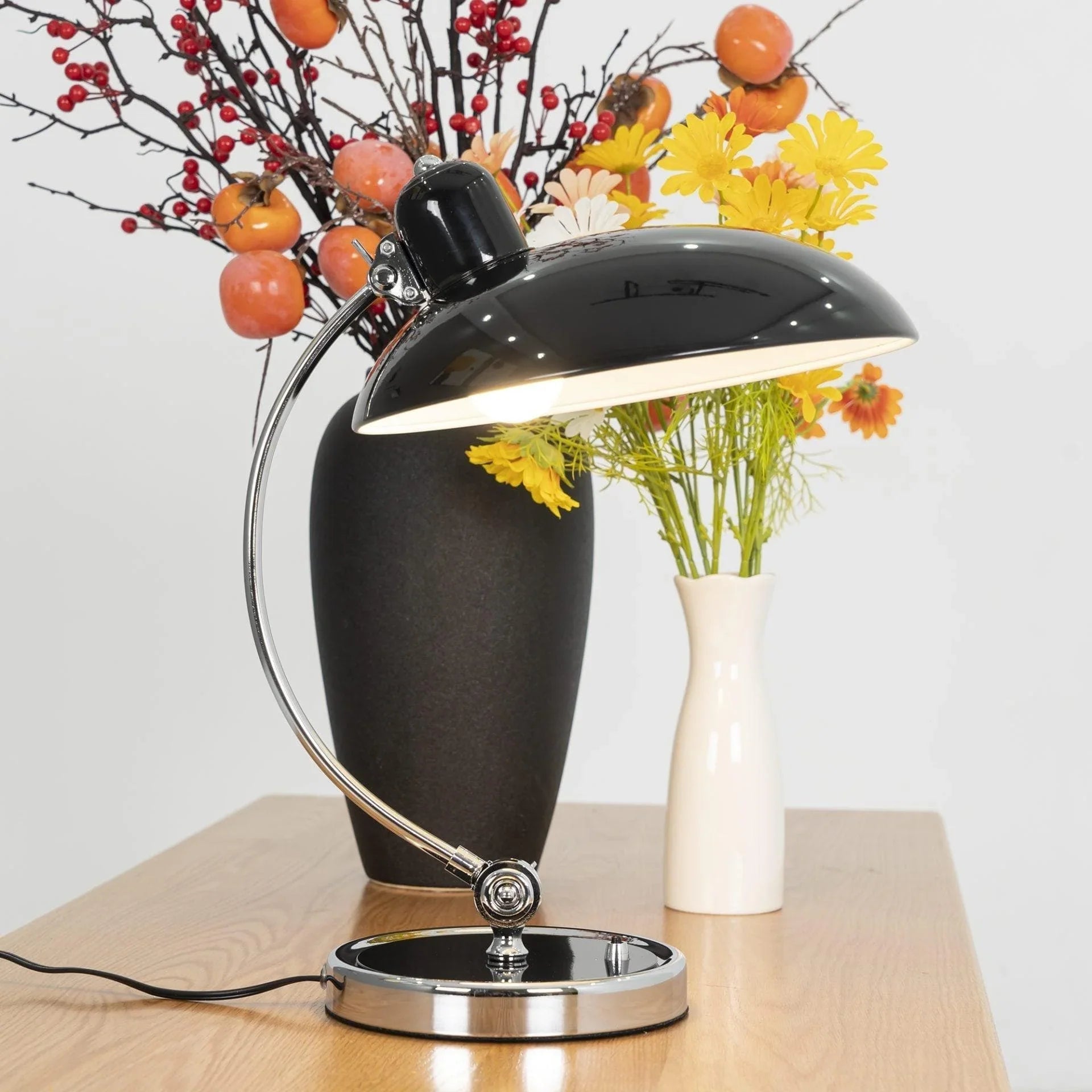 Close-up of polished metal dome and adjustable arm on table lamp