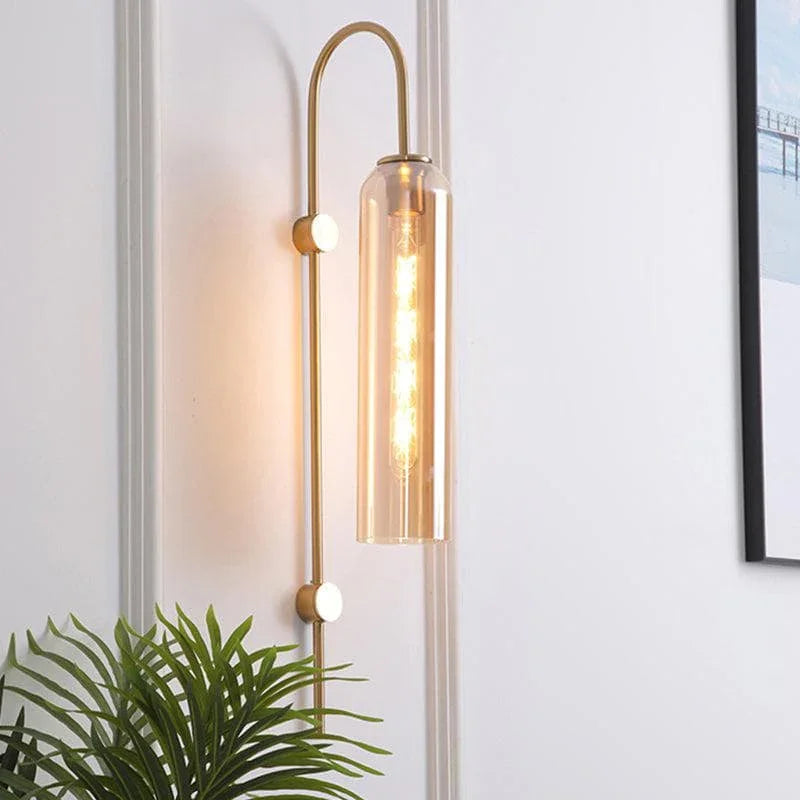 Sleek cylindrical shape of the brass and blown glass wall sconce