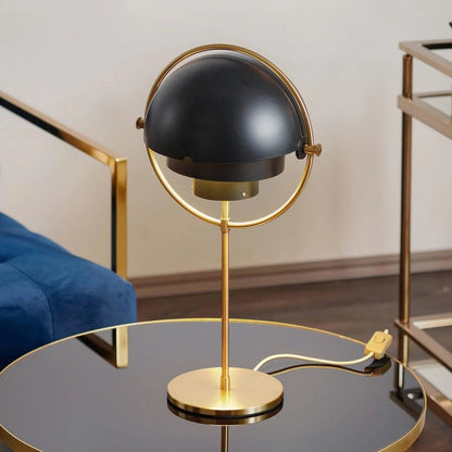 Close-up of layered matte black shade and brass frame detail