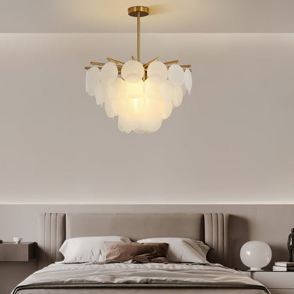 Soft, ethereal light from cascading glass chandelier in a living room