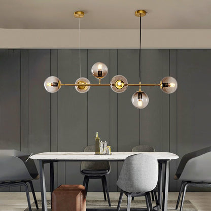 Scalable brass linear chandelier installation with brass accents