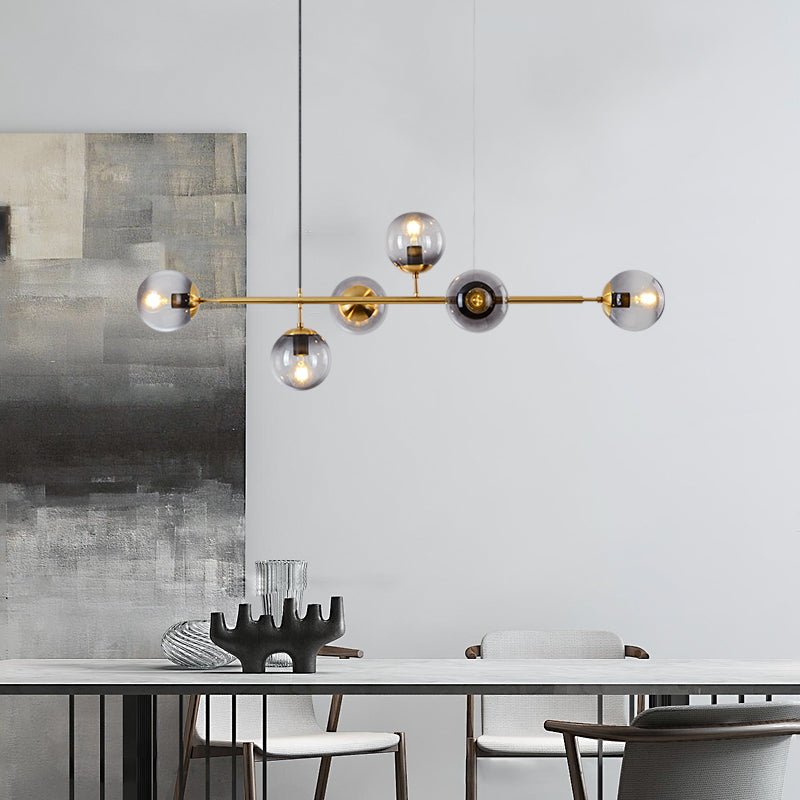 Close-up of hand-blown glass orb detail on brass fixture