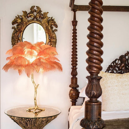 Close-up of soft, dyed ostrich feathers on a brass lamp stem