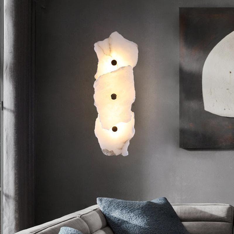 Vertical, layered silhouette of the alabaster wall light