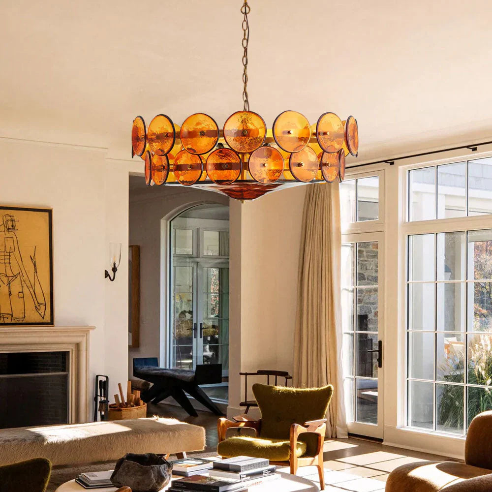 Close-up of textured amber blown glass discs on a brass chandelier