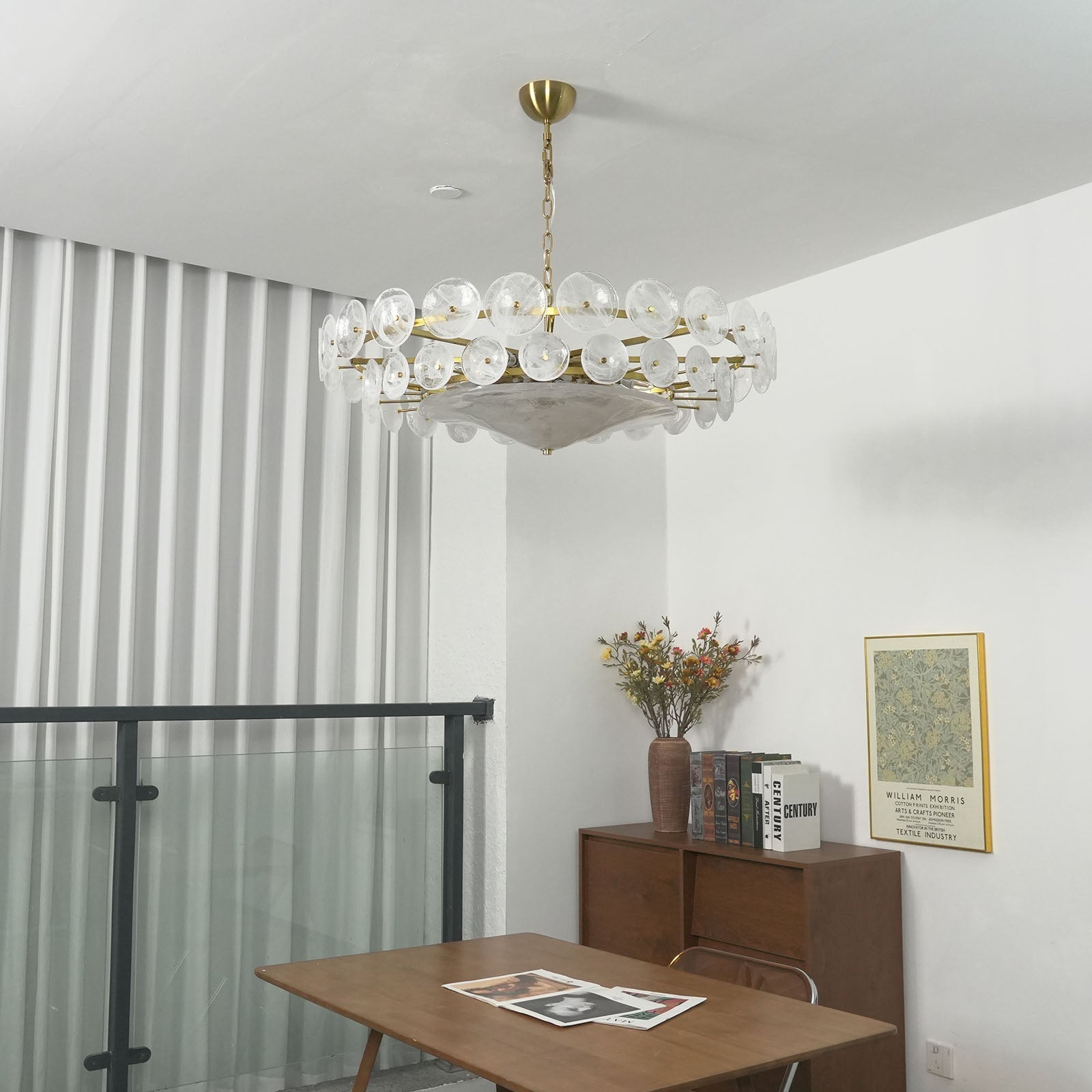 Detail of brass chain and amber glass discs on a chandelier