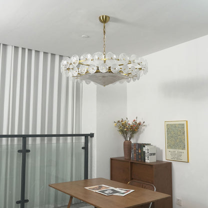 Detail of brass chain and amber glass discs on a chandelier