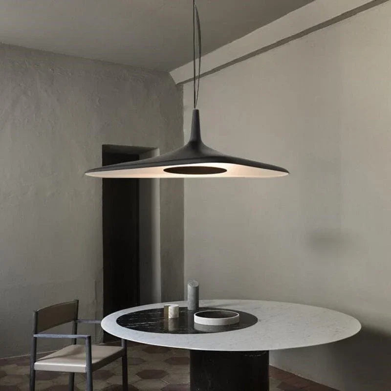 Close-up of the matte black metal finish on the disc pendant light