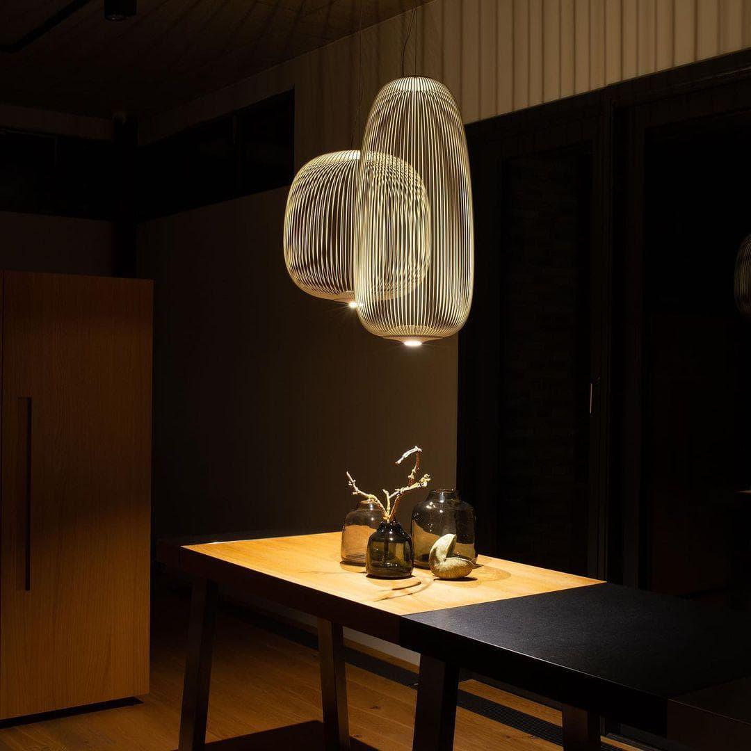Varied organic silhouettes of black wire mesh pendant lights