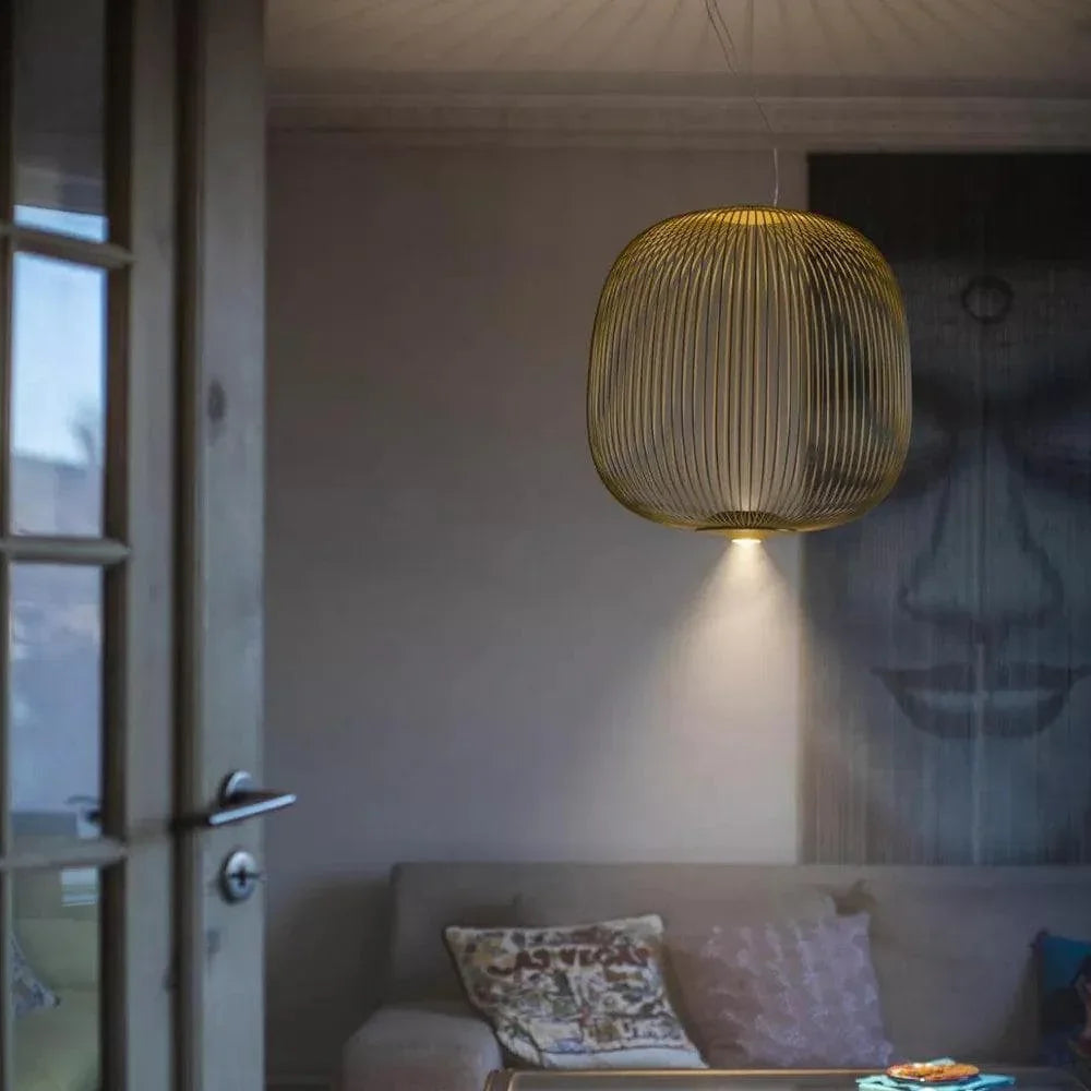 Living room ambiance created by multiple black wire mesh pendant lights