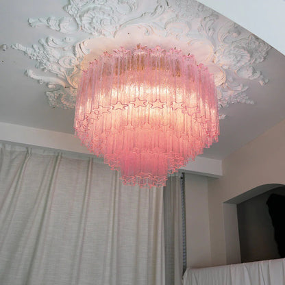 Elegant pink blown glass ceiling light casting a soft glow in a chic room