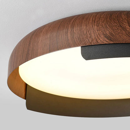 Round silhouette of the wood grain effect ceiling light with dark metal trim